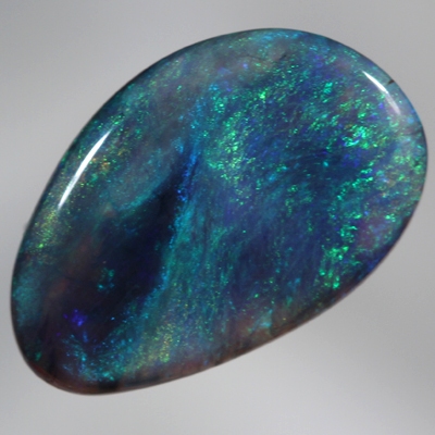 SOLID BLACK CRYSTAL OPAL Constant green and blue fire engulf a patch of black opal